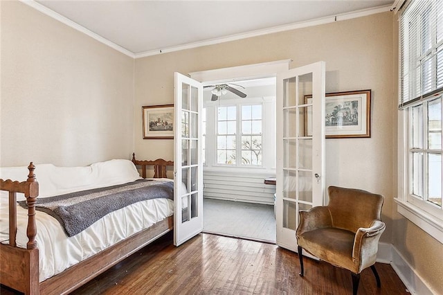 bedroom featuring multiple windows, dark hardwood / wood-style floors, ornamental molding, and french doors