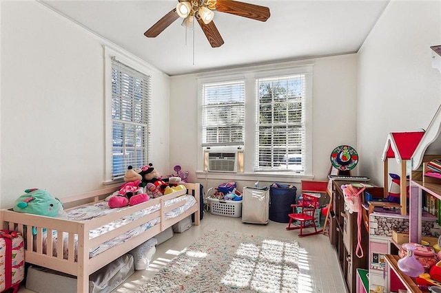 bedroom featuring ornamental molding, cooling unit, and ceiling fan