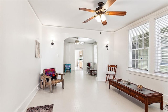 sitting room featuring crown molding and ceiling fan