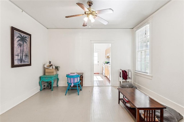 living area featuring ceiling fan and plenty of natural light