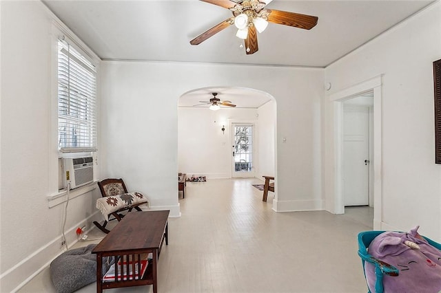 living area with hardwood / wood-style flooring, cooling unit, and ceiling fan