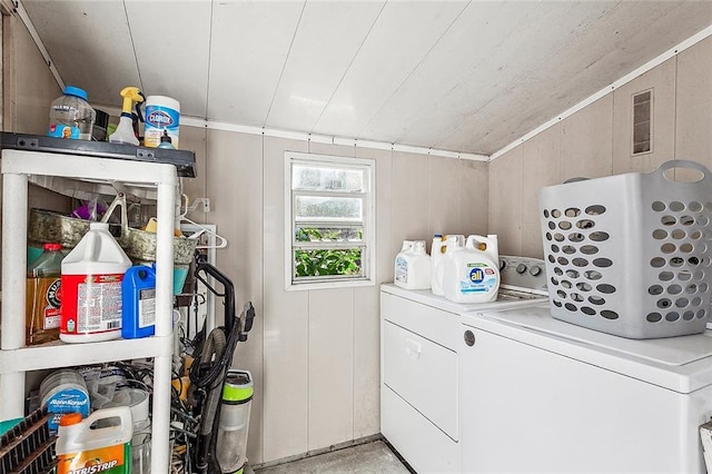 washroom with wood ceiling and washer and clothes dryer