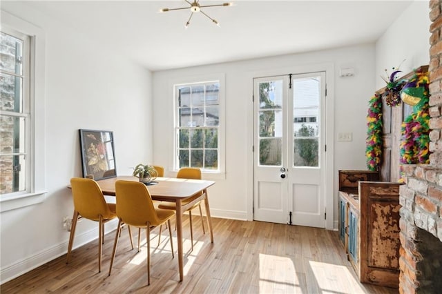 interior space with an inviting chandelier and light hardwood / wood-style floors