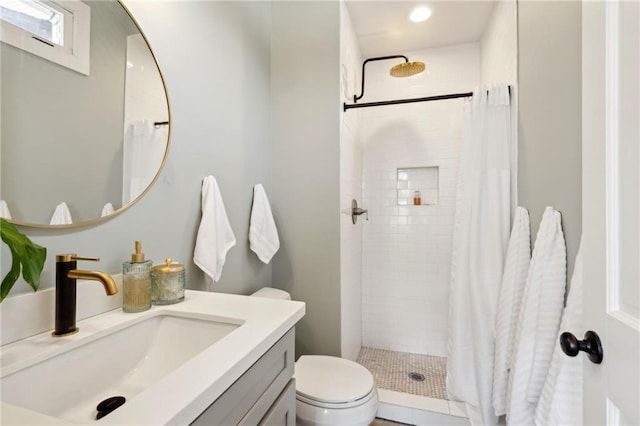 bathroom with toilet, vanity, and a shower with curtain