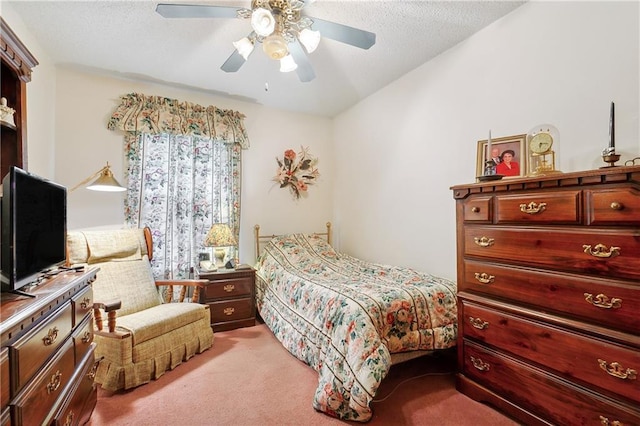 bedroom featuring lofted ceiling, a textured ceiling, a ceiling fan, and carpet floors