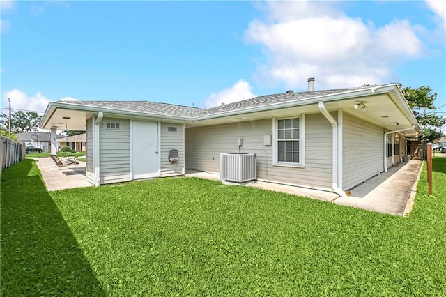 back of house featuring a patio, a yard, fence, and central AC unit