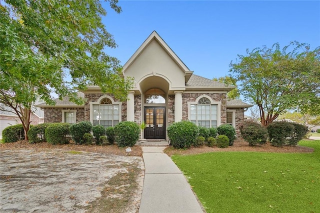 view of front of home featuring french doors and a front yard