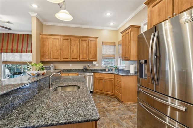 kitchen featuring sink, crown molding, dark stone counters, and appliances with stainless steel finishes