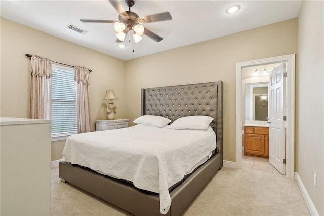 carpeted bedroom featuring ceiling fan and connected bathroom