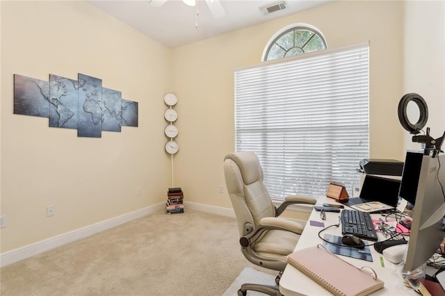 office with light carpet and ceiling fan