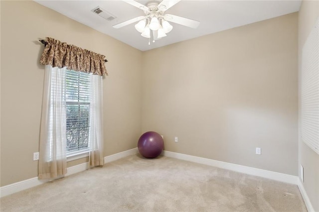 exercise room with carpet floors, baseboards, ceiling fan, and visible vents