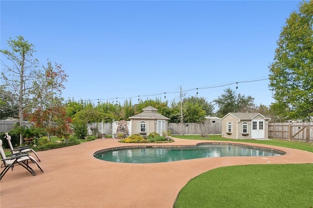 view of swimming pool featuring a patio, an outbuilding, and a lawn