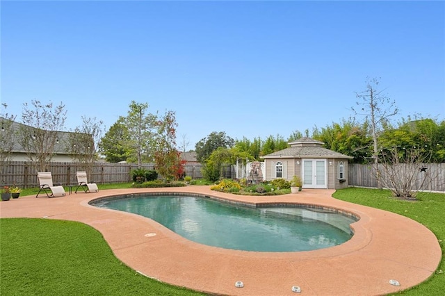 view of pool featuring french doors, a storage structure, an outdoor structure, a fenced backyard, and a patio