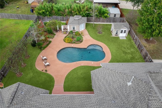 view of pool with a storage shed and a patio area