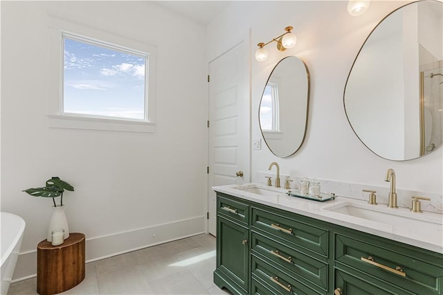 bathroom featuring tile patterned floors, vanity, and a bathing tub