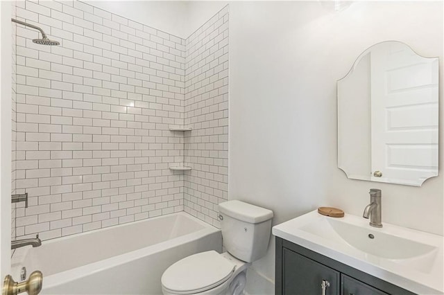 full bathroom featuring vanity, tiled shower / bath combo, and toilet