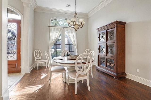 dining room with an inviting chandelier, dark hardwood / wood-style flooring, and crown molding