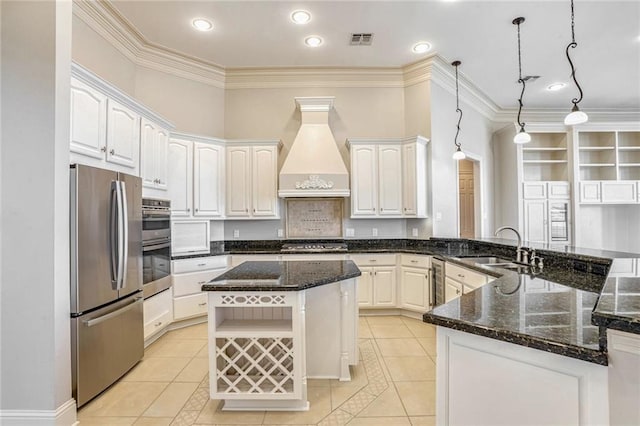 kitchen featuring white cabinetry, stainless steel appliances, decorative light fixtures, custom exhaust hood, and kitchen peninsula