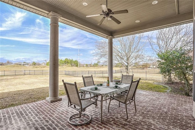 view of patio with ceiling fan and a rural view