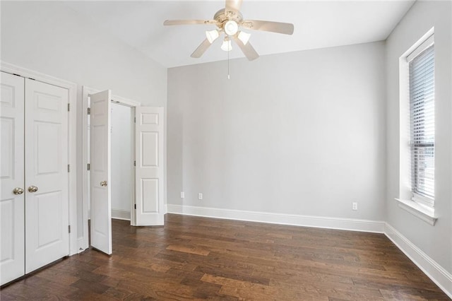 unfurnished bedroom featuring dark wood-type flooring, ceiling fan, and a closet