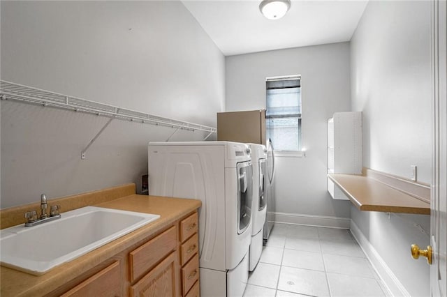 laundry room featuring sink, cabinets, independent washer and dryer, and light tile patterned flooring