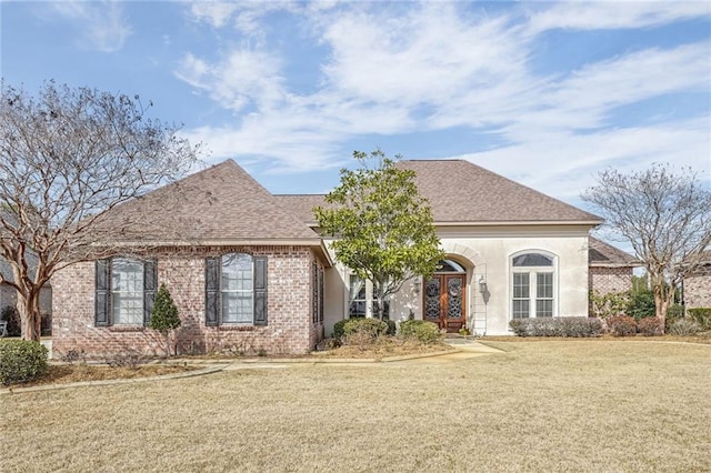 view of front of property featuring a front yard and french doors