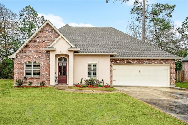 view of front of property with a garage and a front lawn