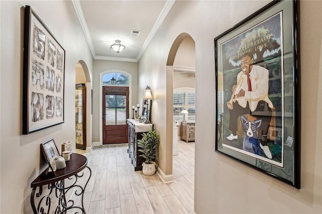 interior space with crown molding and light hardwood / wood-style floors