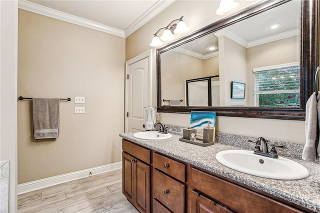 bathroom featuring hardwood / wood-style flooring, ornamental molding, and vanity