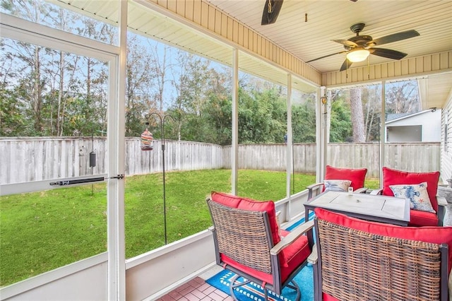 sunroom / solarium featuring a wealth of natural light and ceiling fan