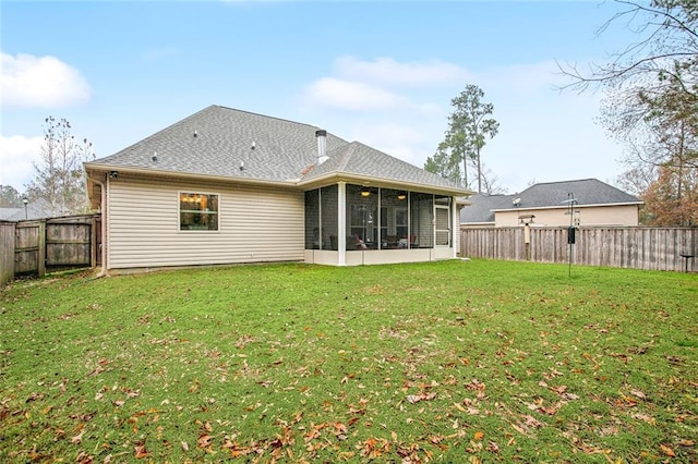 back of house with a yard and a sunroom