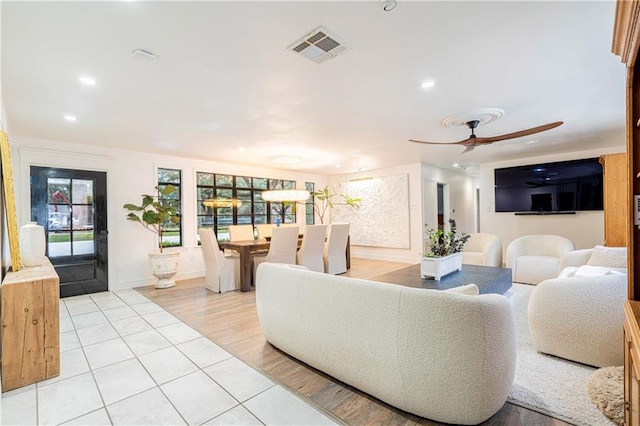 living room with ceiling fan and light tile patterned floors