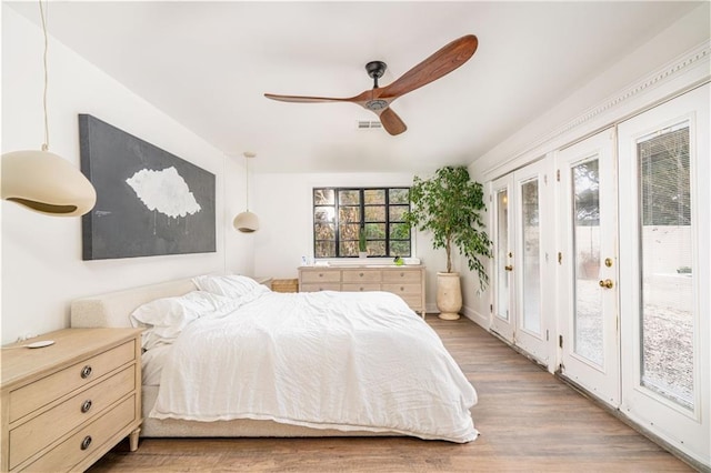 bedroom with ceiling fan, access to outside, and dark hardwood / wood-style flooring