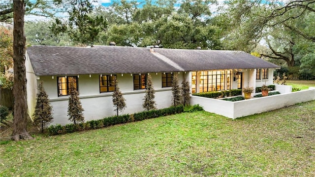 rear view of house with a lawn