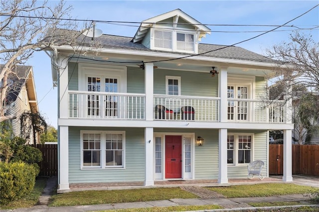 5817 Magnolia St, New Orleans, LA 70115 - view of front of home with a balcony, fence, a ceiling fan, and roof with shingles