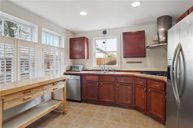 5817 Magnolia St, New Orleans, LA 70115 - kitchen with appliances with stainless steel finishes, wall chimney range hood, a sink, recessed lighting, and dark brown cabinets