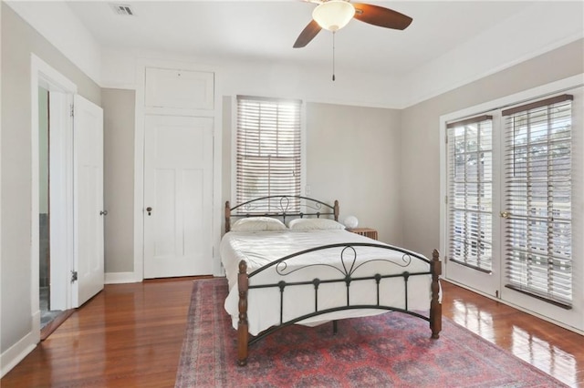 5817 Magnolia St, New Orleans, LA 70115 - bedroom with multiple windows, wood finished floors, baseboards, and access to outside