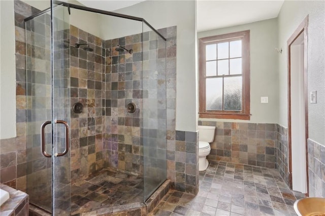 bathroom with walk in shower, toilet, and tile walls