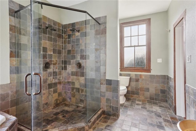 5817 Magnolia St, New Orleans, LA 70115 - full bath featuring toilet, a stall shower, tile walls, and wainscoting