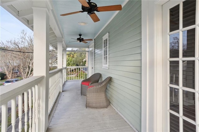 balcony with ceiling fan and a porch