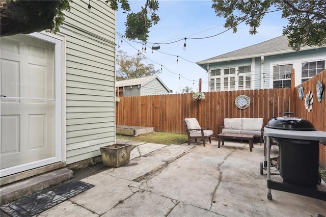 5817 Magnolia St, New Orleans, LA 70115 - view of patio / terrace with a fenced backyard, an outdoor living space, entry steps, and a grill