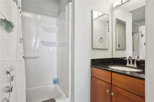 bathroom featuring vanity and shower / bathtub combination with curtain