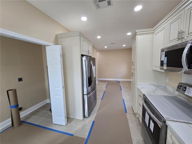 kitchen with white cabinetry, light tile patterned floors, and appliances with stainless steel finishes