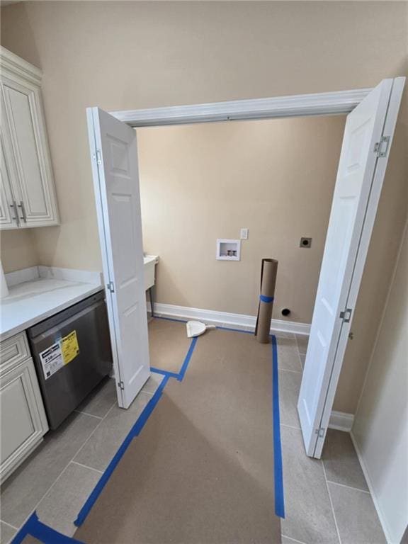 laundry room featuring hookup for an electric dryer, washer hookup, and light tile patterned floors