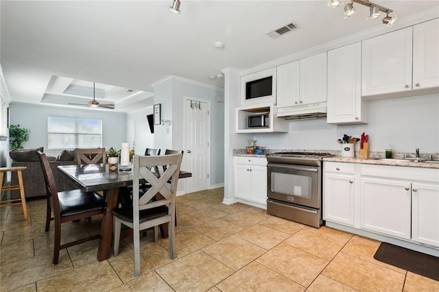 kitchen with white cabinetry, ceiling fan, stainless steel appliances, and a raised ceiling