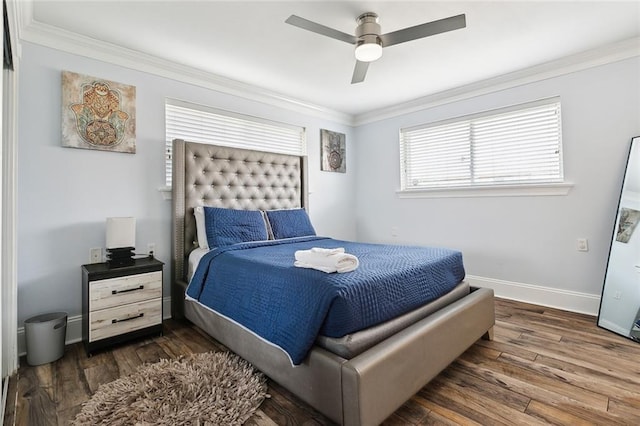 bedroom featuring ceiling fan, ornamental molding, and dark hardwood / wood-style flooring