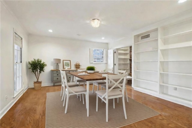 dining space with hardwood / wood-style floors