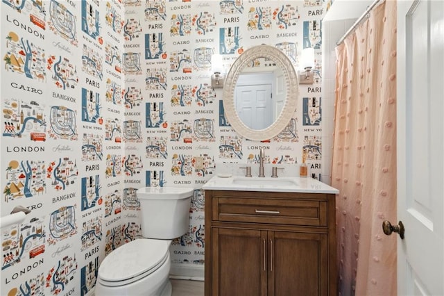 bathroom featuring vanity, a shower with shower curtain, and toilet