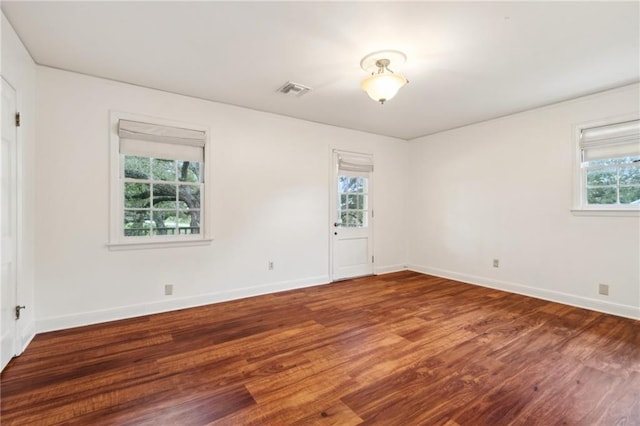 spare room with hardwood / wood-style floors