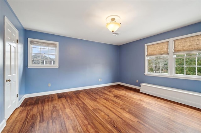 empty room with hardwood / wood-style floors